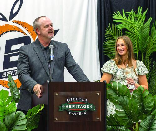 Osceola County Athletic Director Ryan Adams presents the Female Athlete of the Year Award to Harmony High's Kinzie James. (Photo/Taylor McFee)