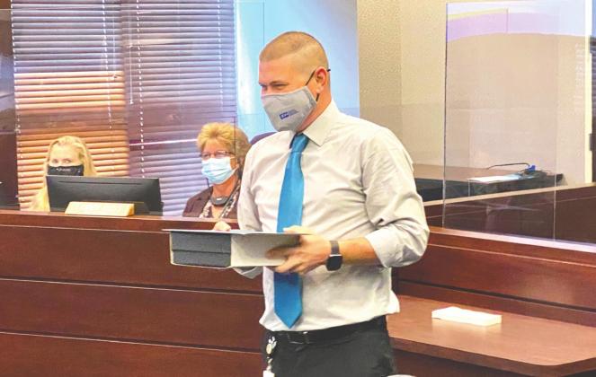 Information Security Analyst Brandon Pritchett receives the Osceola County employee of the year award during a Osceola County Commission meeting. OSCEOLA NEWS-GAZETTE PHOTO/BRIAN MCBRIDE