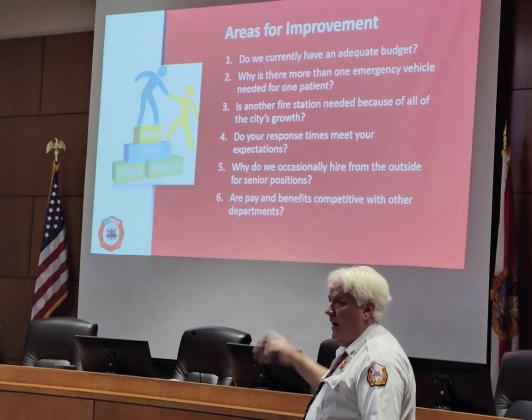 Kissimmee Fire Department Chief Jim Walls goes over a list of stragetic initiatives the fire force hopes to address through its accreditation process at a public workshop Aug. 31.  PHOTO/KEN JACKSON