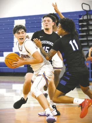 Osceola’s Jordan Isaac (11) and Helio Quinan (15) guard Harmony’s Jeremy Penner in the season opener last week. The Kowboys defeated the Longhorns and Davenport High to start the season 2-0. PHOTO/KATIE WILLIAMS