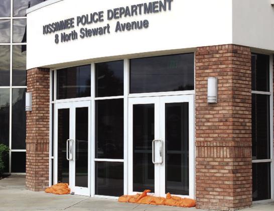 Downtown Kissimmee businesses—and the Kissimmee Police Department—prepped properly to protect property by Tuesday, the last “business as usual” day before Hurricane Milton was set to arrive. Residents lined up Tuesday at OHP (center) to get last-minute sandbags. PHOTO/KEN JACKSON