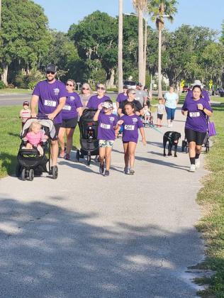 Participants in the inaugural Drowning Awareness 5K Run made the jogging path along Lakeshore Boulevard awash in purple. PHOTO/KEN JACKSON