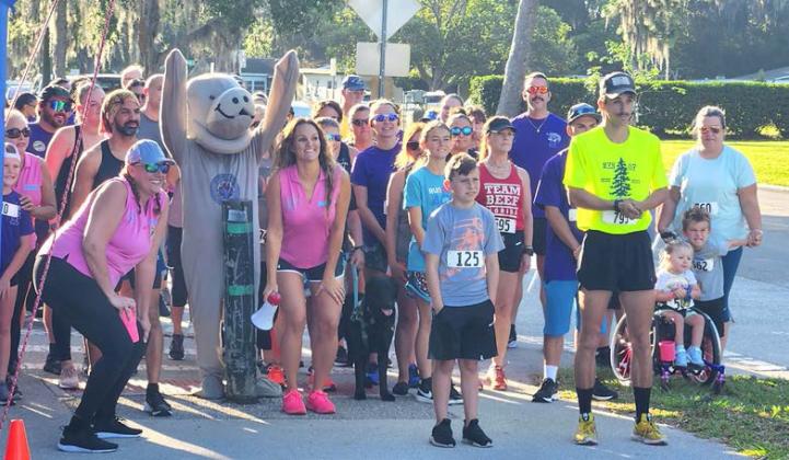 Marley the Manatee gets runners ready to start the Drowning Awareness 5K Run. PHOTO/KEN JACKSON