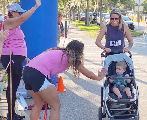 Rebecca Bond Abele, the co-founder and lead instructor for Safety First Pediaquatics in St. Cloud, greets one of Saturday's youngest participants. PHOTO/KEN JACKSON
