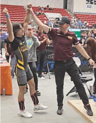 Found more gold: St. Cloud weightlifter Mikey Ziss (left) and Coach Cory Aun celebrate two more state championships, as Ziss won the traditional and Olympic discipline titles for the third straight year at the Class 3A state meet. (Photo/St. Cloud High School)
