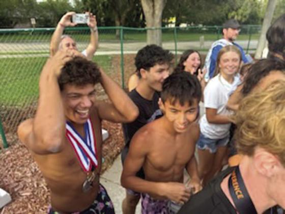 Jubliant Celebration High swim teams celebrate winning both the boys and girls Orange Belt Conference team titles Thursday. SUBMITTED PHOTOS