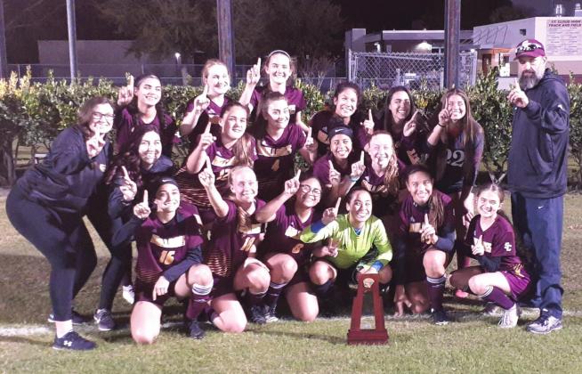 The St. Cloud Lady Bulldogs soccer team poses with the Class 6A, District 9 trophy following a 3-1 win over East River. NEWS-GAZETTE PHOTO/J. DANIEL PEARSON