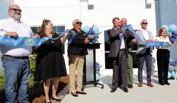 City and developer officials cut the ribbon Friday on Mosaic, downtown Kissimmee’s first high-density residential project. PHOTO/KEN JACKSON
