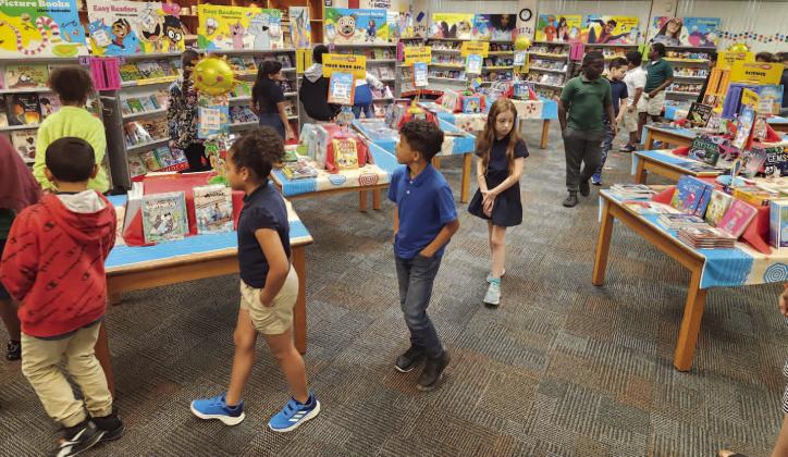 Third grade students at Mill Creek Elementary tour the school’s book fair this week. Corporate and county sponsors covered the cost of each student buying a book to take home. PHOTO/KEN JACKSON