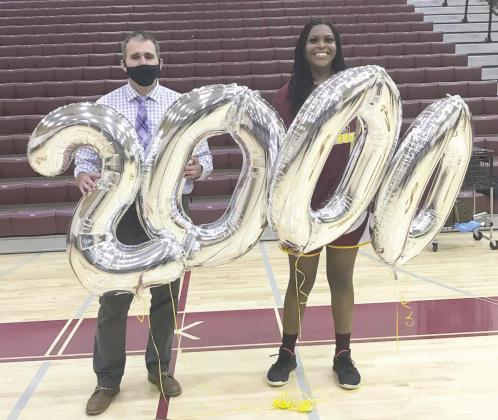Eno Inyang and Head Coach Chad Ansbaugh hold up balloons commemorating Inyang’s 2,000 career points at St. Cloud High School. The second all-time leading scorer in the county, Inyang is headed for Clemson in the fall and is the Osceola News Gazette’s Player of the Year for 2020-21 PHOTO/ST. CLOUD HIGH SCHOOL