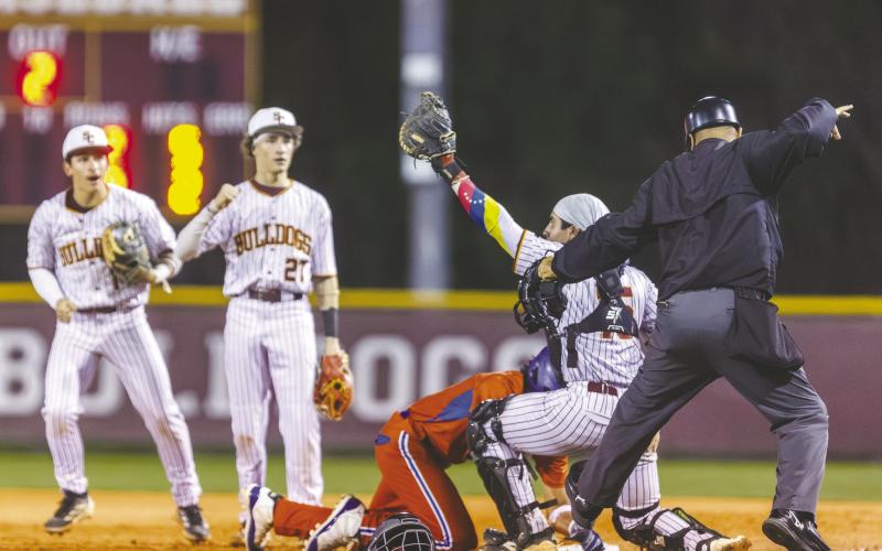 St. Cloud’s defense played the rundown perfectly Friday, as catcher Samuel Quijada tags Harmony’s Angel Medina at first base while Nathan Bianco (1) and Jayden Luciano (27) back up the play. (Photo/Taylor McFee)