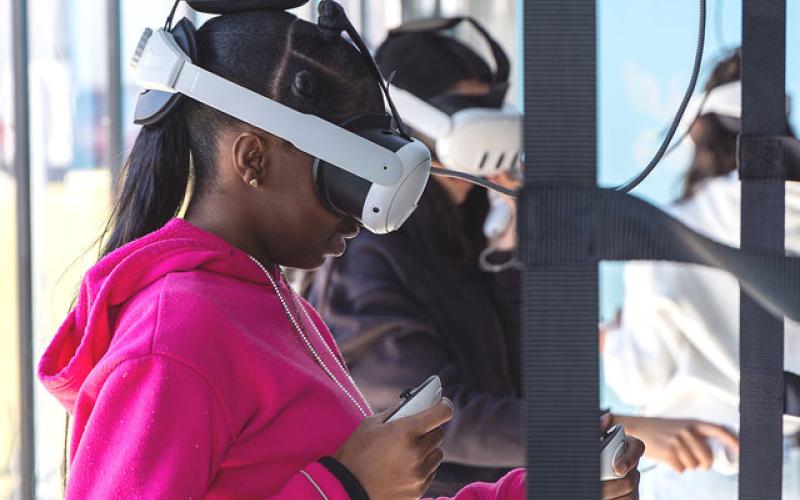 Tohopekaliga High students try their hands at landing a fighter jet on aircraft carrier on the “Fly” Experience and other virtual reality missions at last week’s U.S. Navy Strike Group Experience tour. (Photo/Taylor McFee)