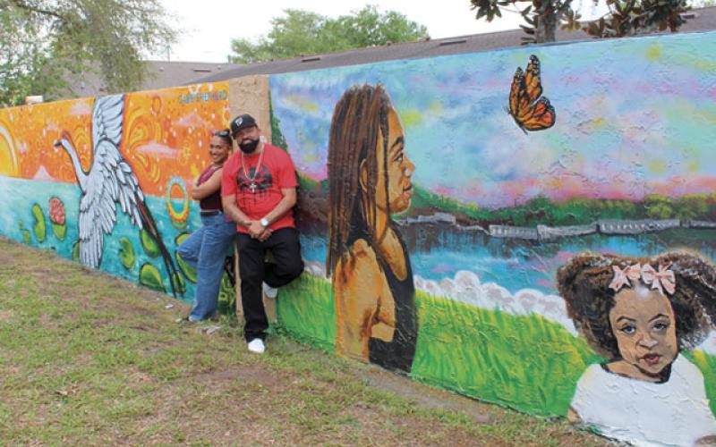 Artists Gabriella Shepherd and Eric “The Wise Knight” Wise (pictured), Jennifer Veal and Mike “2Esae” Baca collaborated on 180 feet of wall mural adjacent to The Transition House in Kissimmee in the latest installment of Osceola Arts’ ARTisNOW public works project. (Photos/Ken Jackson)