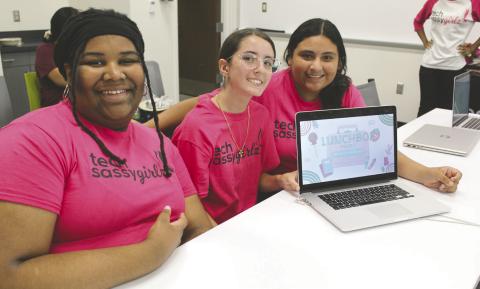 Osceola High and St. Cloud sophomores Lyric Williams, Biana Maandez and Liaian Brandan (from left) show off their “Lunchbox” AI chat bot they created during the Tech Sassy Girlz “Pearls in Tech Accelerator” summer program July 30 at Valencia College. (Photo/Ken Jackson)