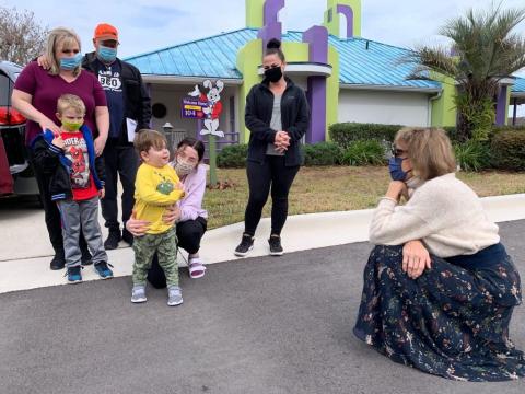 Give Kids The World President and CEO Pamela Landwirth greets a family at the village.