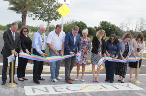 The cutting of the ribbon to NeoCity Way