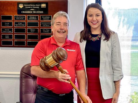 "Carry a Big Stick" — Adrianna Sekula passes the gavel as Kissimmee/Osceola County Chamber of Commerce Board Chairman to Kevin Crain.