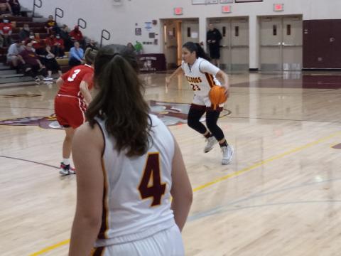 Danigzy Mantilla (23) starts to drive the lane against Emily Shook (3) during St. Cloud’s 52-33 regional quarterfinal win Thursday night. PHOTO/DAN PEARSON