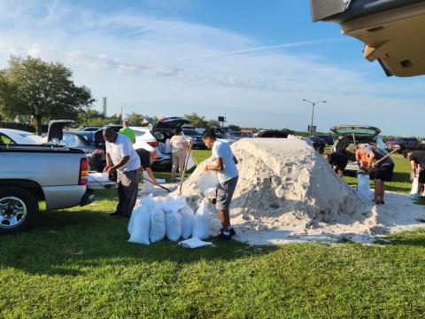 Residents work to fill sandbags Monday morning at Osceola Heritage Park ahead of Hurricane Ian. The area could receive 4-8 inches of rain. PHOTO/KEN JACKSON