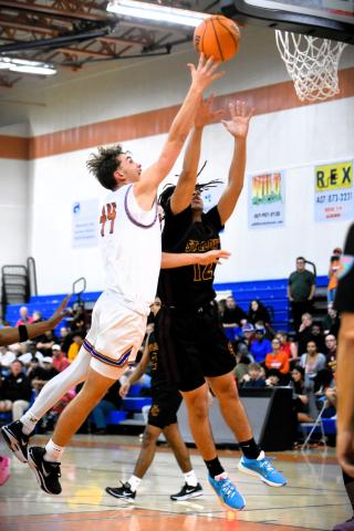 Harmony's Sylus Cory (44 in white) and St. Cloud's Ryan Rodriguez go for a rebound in Wednesday's wild OBC tournament semifinal, a 54-52 Bulldogs win. PHOTO/KATIE WILLIAMS