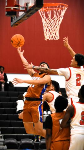 Harmony’s Vlad Torrado goes up for a shot, and Gateway’s Sebastian Vazquez provides the physical defense, in Friday’s Longhorns win that spoiled the grand opening of the new Panther gym. PHOTO/KATIE WILLIAMS