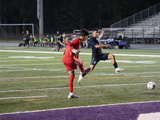 Celebration midfielder Anyelo Castellano challenges Olympic Heights goalie Antonio Andrade for the ball in Friday's Class 7A regional quarterfinal. PHOTO/MARIO CASAMALHUAPA 