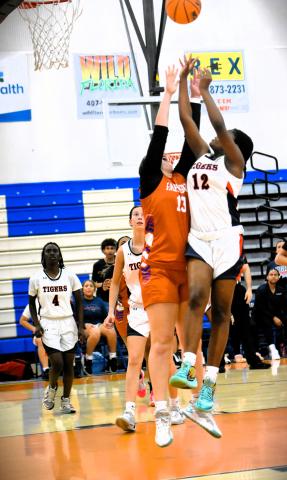 Tohpekaliga's DD Parks (12) and Harmony's Emerson Aslan fight for a rebound in Friday's District 7A-6 final, a 38-32 Tigers' win. PHOTO/KATIE WILLIAMS