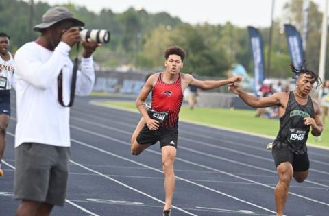 Gateway’s Jose Calderon stretches at the tape in the finals of the Class 4A state meet 400 meter run, where he finished seventh. PHOTO/JULIE ANDREW