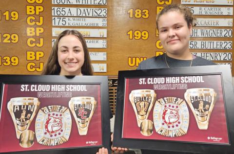 Reese Butler (left) and Ashley Aun (right) show off their championship ring photos for winning state titles in weightlifting. PHOTO/CORY AUN