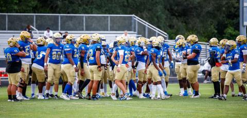 Osceola warms up for its game Friday against Treasure Coast. Thunderstorms pulled them off the field for nearly two hours before the game kicked off and the Kowboys won, 21-7. PHOTO/TAYLOR MCFEE