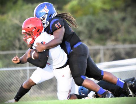 Harmony defensive lineman Mekhi Ealy drags down Poinciana quarterback Cameron Brown in Friday's 26-5 Eagles victory. PHOTO/KATIE WILLIAMS