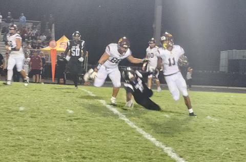 Alex Springs (11) runs a sweep Friday for St. Cloud in a 23-10 loss to Lake Nona, the first District 7A-10 game for both teams. PHOTO/KEN JACKSON