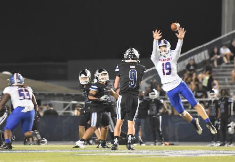 Harmony's Ty Brooks goes sky-high to try to bat down Lake Howell quarterback Luke Barhorst's pass in Friday's 40-18 Silver Hawks win. PHOTO/KATIE WILLIAMS