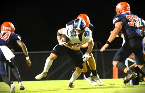 Tohopekaliga spent Friday chasing Hagerty running backs. Porter Williams carries Friday as Tohopekaliga's Nathan Freeze (24) and Ryan Wells (33) move in to make a tackle. PHOTO/KATIE WILLIAMS