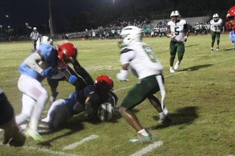 Will Nezius fights for yardage in Poinciana's **-** loss to Evans Friday at Eagle Field. PHOTO/KEN JACKSON