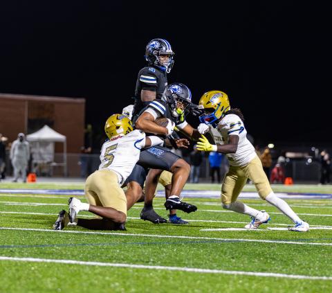 Osceola defensive backs Jeff Banks (5) and Jakyri Watson (2) converge on Armwood receiver Tyler Williams in the Kowboys' 17-7 Region 6A-2 final win Friday over the Hawks. PHOTO/TAYLOR MCFEE