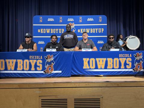 With Coach Eric Pinellas in the background, (from left) Elijah Melendez (Auburn), Robert Lee (FAU), Connor Howse (Ole Miss) and Taevion Swint prepare to make their college choices known. Swint ended up delaying his announcement. PHOTO/J. DANIEL PEARSON