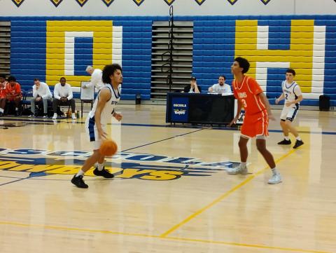 Osceola’s Luke McCrimon (with the ball) gets ready to set up a play against Ovideo’s Cameron Bryant (3). The Kowboys won the game 60-45. PHOTO/J. DANIEL PEARSON