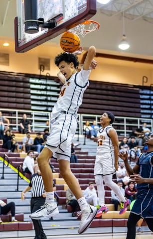 St. Cloud's Lenual Narvaez throws down a dunk in the Bulldogs' blowout win Wednesday over Lake Nona. Elias Torres (33) clearly approves. PHOTO/TAYLOR MCFEE
