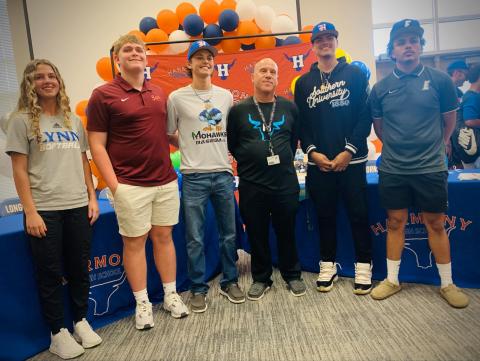 Signing Day at Harmony: from left, Haley Diaz (Lynn), Clayton Williams (Maryville), Tanner Chapman (John Melvin Christian), Alexaiver Lebron (Southern), Ismael Rivera (Eastern Florida) and Sam Castillo (Chipola, not pictured) signed to play college ball on National Signing Day Wednesday. PHOTO/KATIE WILLIAMS