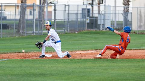 Harmony's Jose Scrofani slides into third as Osceola third baseman Ethan Grant in the Longhorns' 16-6 win Feb. 25. PHOTO/TAYLOR MCFEE 