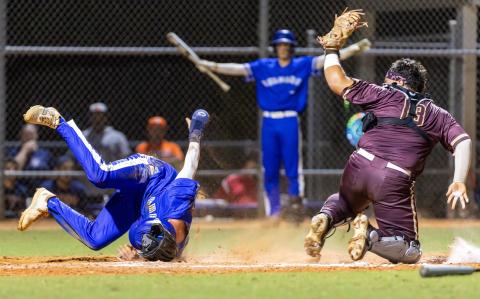 It was a wild, rough-and-tumble night for baseball at Tohopekaliga High Friday, where Harmony (in blue) topped St. Cloud, 7-6 in the Orange Belt Conference championship game. PHOTO/TAYLOR MCFEE