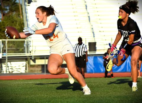 Harmony's Kinzie James runs from a Celebration defender and stretches for yardage in the Longhorns' 26-6 win over Celebration in the District 4A-10 championship game. PHOTO/KATIE WILLIAMS
