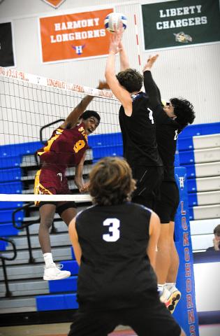 St. Cloud's Dante Cayaban goes up over the net for a hit against the Celebration defense in Friday's Orange Belt Conference volleyball championship at Harmony High School. PHOTO/KATIE WILLIAMS