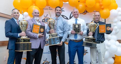 St. Cloud High School swept the Orange Belt Conference academic, athletic and community service awards at the School District’s annual banquet. From left, this pack of Bulldogs is Coach Cory Aun, Athletic Trainer of the Year Craig Carnell, Coach Shane Muller, SCHS Coach of the Year Kevin Harkema and Athletic Director Bryan Smart. (Photo/Taylor McFee)