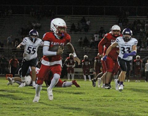 Poinciana's Kamari Lewis (8) rushes to mid-field while Celebration's Michael Macera (33) pursues at Poinciana High School on Friday. (Photo/Michelle Kostuch)