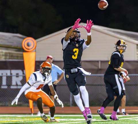 St. Cloud receiver Stacy Taylor hauls in a pass from Jeremiah Lattier in the Bulldogs district-clinching win last week. The two, and other receivers, will have to connect to find a win against rival Harmony on Friday. (Photo/Taylor McFee)