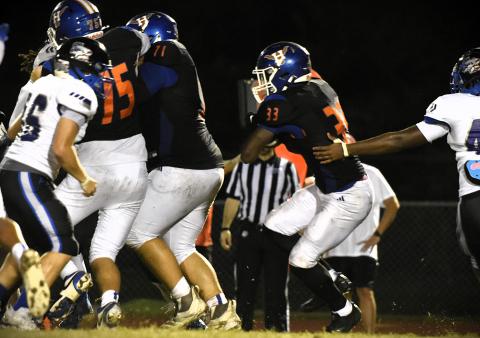 Damarion Moore (33) helped Harmony move the ball Friday with 55 rushing yards against Lake Nona. (Photo/Katie Williams)