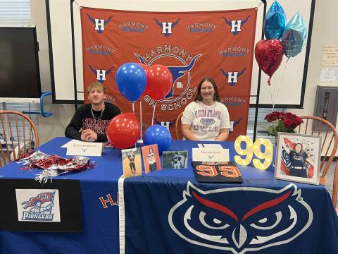 Harmony High swimmer Aaron Stephenson and softball player Emerson Aslan sign their scholarships at the opening of the college signing window last week. (Submitted Photo)