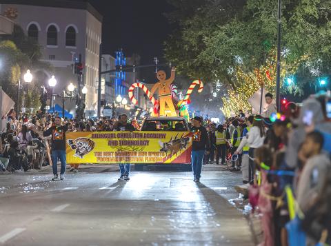 Celebrating the holiday in Kissimmee — thousands turned out for the City of Kissimmee Festival of Lights Parade. (Photo/Taylor McFee)